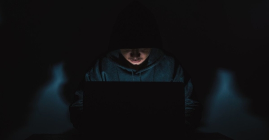 A hacker committing white collar crime